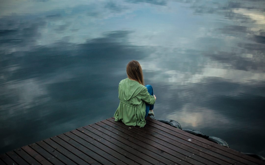 Woman sitting on dock